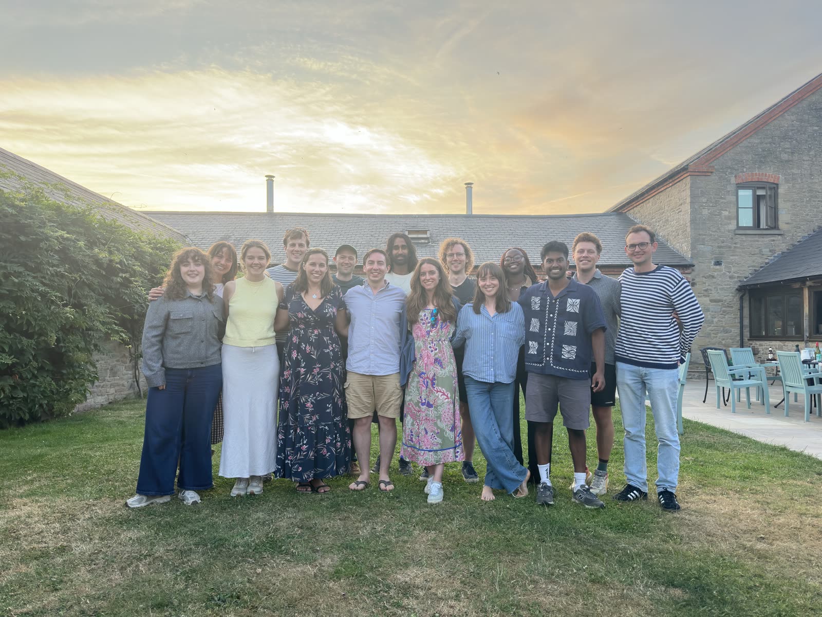 The Plinth team standing together in a garden at sunset